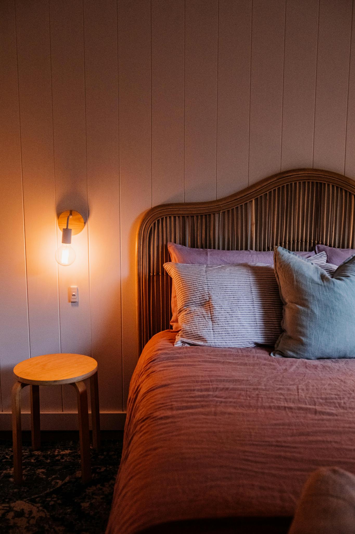 Warm and inviting bedroom interior with stylish bedding and ambient lighting. Perfect for home decor inspiration.